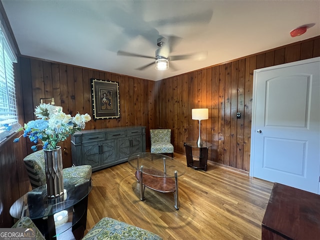 2833 Oldknow Dr NW, Atlanta, GA 30318 - living area featuring light wood-style floors, wood walls, and ceiling fan