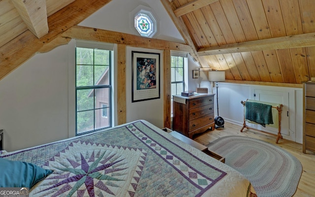 bedroom featuring lofted ceiling with beams and light wood-style flooring