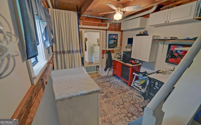 interior space featuring wood ceiling, ceiling fan, and laundry area