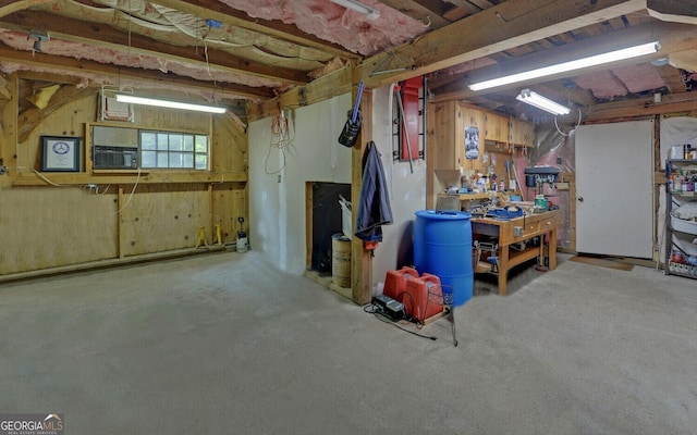 basement with cooling unit and a workshop area