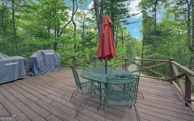 wooden deck with grilling area and outdoor dining space