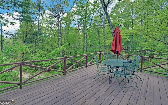 wooden deck featuring outdoor dining space