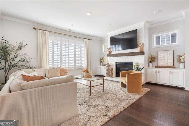 living room featuring ornamental molding, dark wood-style flooring, and a brick fireplace