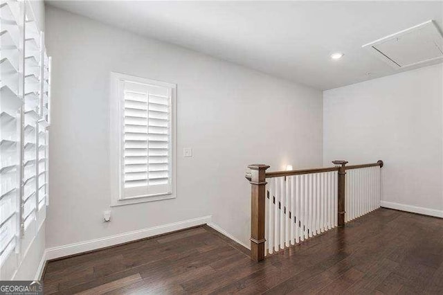 interior space with recessed lighting, baseboards, wood finished floors, and attic access