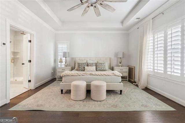 bedroom featuring a ceiling fan, baseboards, dark wood-style floors, and a raised ceiling