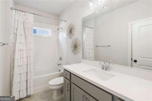 bathroom featuring vanity, shower / bath combo, and toilet