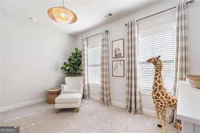 sitting room with carpet floors, baseboards, and visible vents