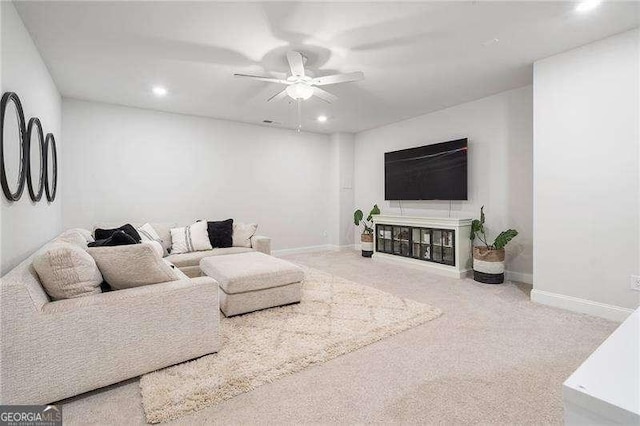 living area with carpet floors, baseboards, a ceiling fan, and recessed lighting
