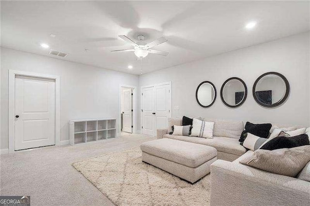 carpeted living area featuring recessed lighting, a ceiling fan, and visible vents