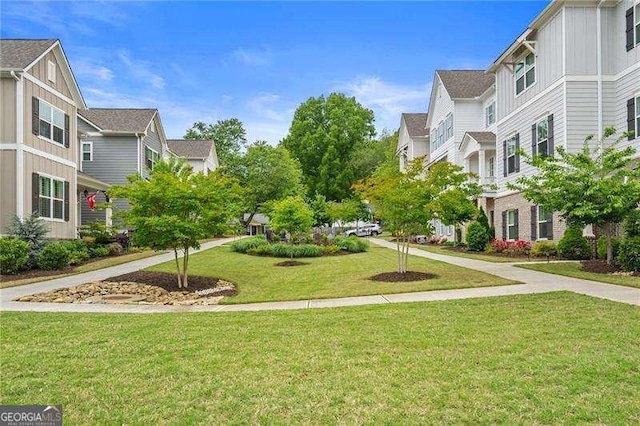 surrounding community with a yard and a residential view