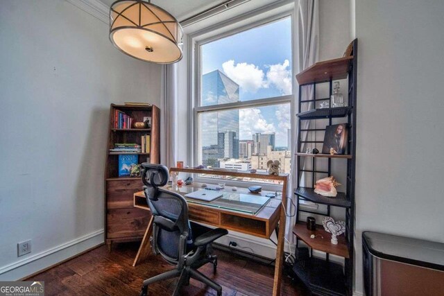 office featuring baseboards, a view of city, and wood finished floors