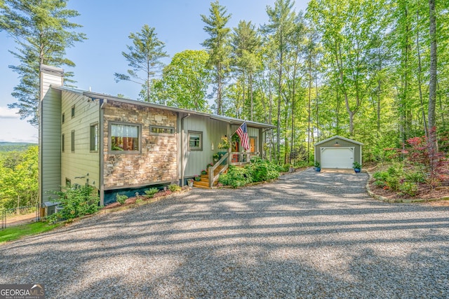 454 N Old Aska Rd, Blue Ridge, GA 30513 - view of front of house with an outdoor structure, stone siding, a detached garage, a chimney, and fence