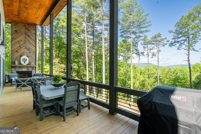 454 N Old Aska Rd, Blue Ridge, GA 30513 - sunroom with a fireplace and outdoor dining space