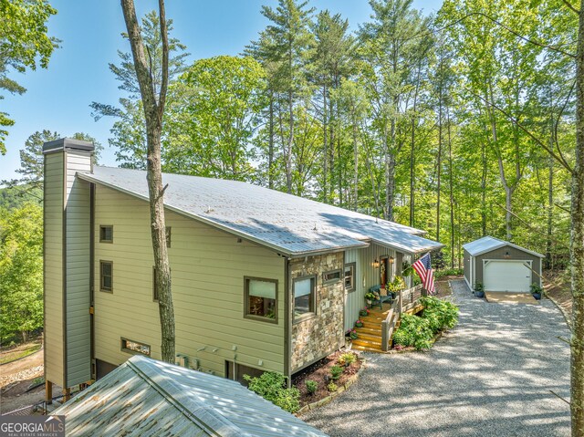 454 N Old Aska Rd, Blue Ridge, GA 30513 - view of front of property with an outdoor structure, a detached garage, a chimney, driveway, and metal roof
