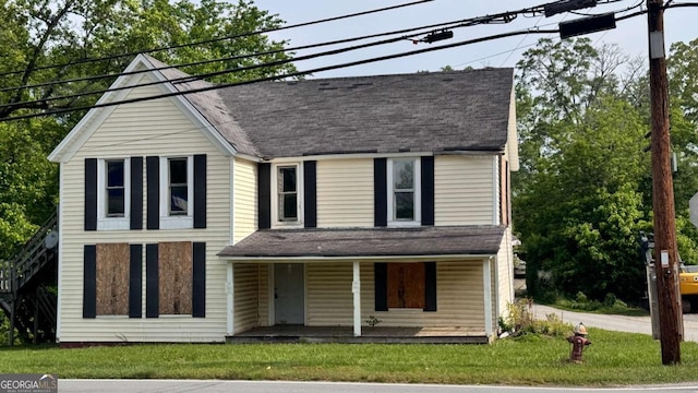 700 W College St, Bowdon, GA 30108 - view of front of house with a porch, a shingled roof, and a front yard