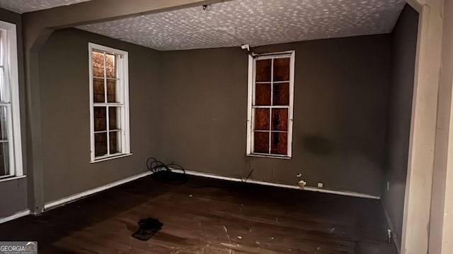 700 W College St, Bowdon, GA 30108 - spare room with a textured ceiling, baseboards, and wood finished floors
