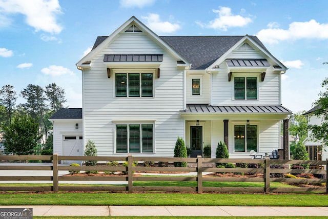 2201 Old Dallas Rd SW, Marietta, GA 30064 - modern farmhouse style home with covered porch, a fenced front yard, roof with shingles, and a standing seam roof