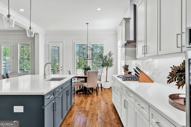 2201 Old Dallas Rd SW, Marietta, GA 30064 - kitchen featuring a sink, wall chimney exhaust hood, crown molding, light wood-type flooring, and light countertops