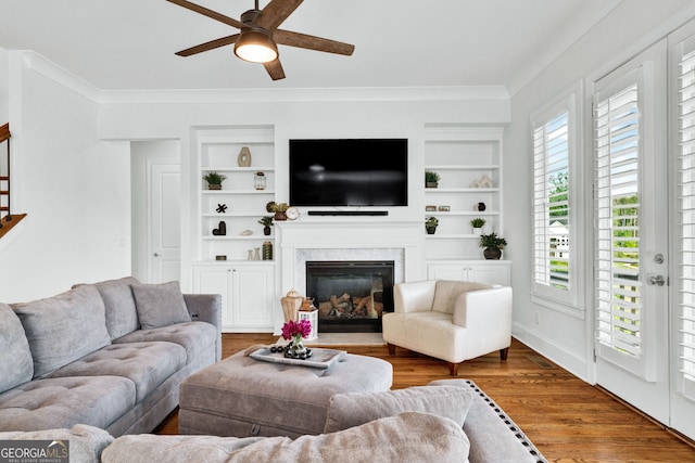 2201 Old Dallas Rd SW, Marietta, GA 30064 - living area featuring built in features, a ceiling fan, ornamental molding, and a high end fireplace