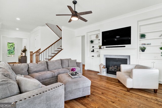 2201 Old Dallas Rd SW, Marietta, GA 30064 - living room with wood finished floors, built in features, ceiling fan, ornamental molding, and stairs
