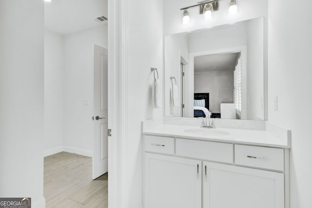 2201 Old Dallas Rd SW, Marietta, GA 30064 - ensuite bathroom with wood finished floors, vanity, ensuite bath, visible vents, and baseboards