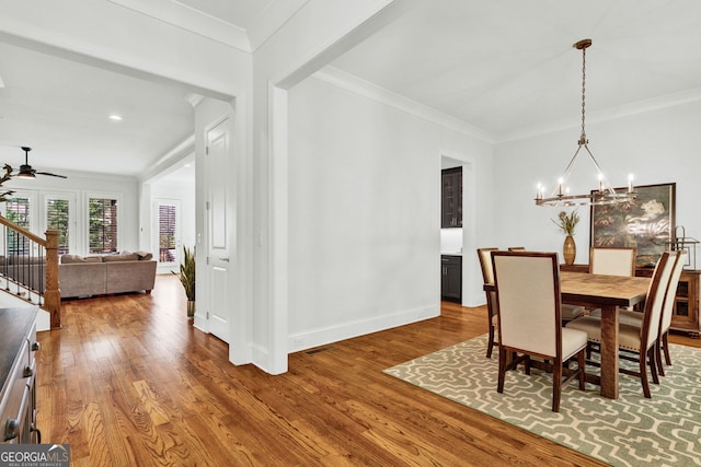 2201 Old Dallas Rd SW, Marietta, GA 30064 - dining room with baseboards, ceiling fan with notable chandelier, crown molding, and wood finished floors