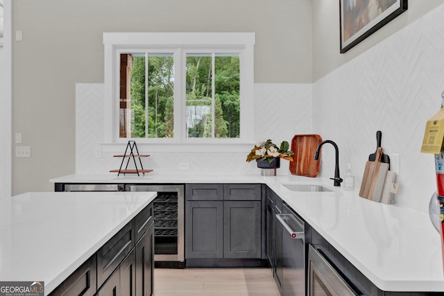 2201 Old Dallas Rd SW, Marietta, GA 30064 - bar with beverage cooler, decorative backsplash, stainless steel dishwasher, and a sink
