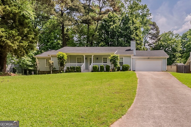 228 Amour Way SW, Lilburn, GA 30047 - ranch-style home featuring fence, a garage, concrete driveway, a front yard, and a porch