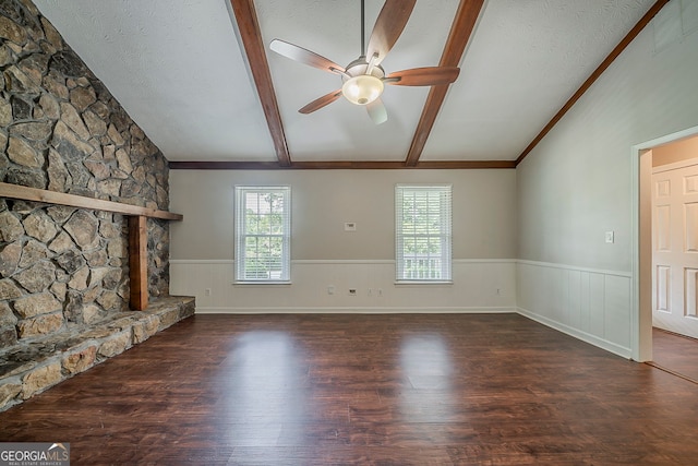 228 Amour Way SW, Lilburn, GA 30047 - unfurnished living room featuring wainscoting, lofted ceiling with beams, a ceiling fan, and wood finished floors