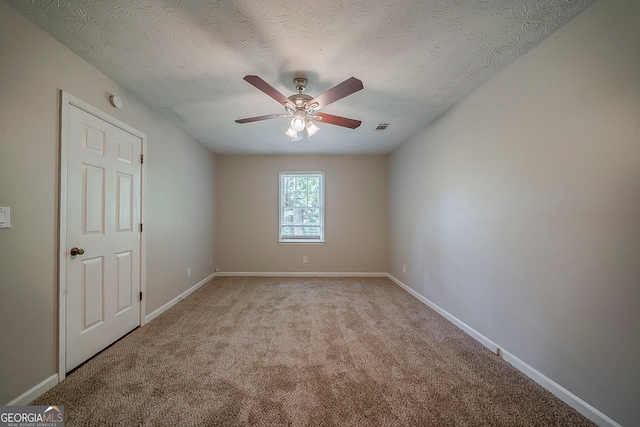 228 Amour Way SW, Lilburn, GA 30047 - spare room with a textured ceiling, visible vents, baseboards, ceiling fan, and light colored carpet