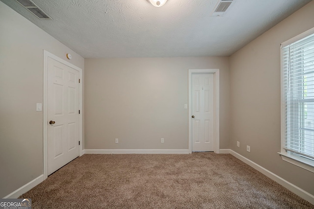 228 Amour Way SW, Lilburn, GA 30047 - unfurnished room featuring carpet flooring, plenty of natural light, and visible vents