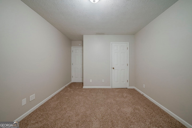 228 Amour Way SW, Lilburn, GA 30047 - unfurnished bedroom with baseboards, a textured ceiling, visible vents, and light colored carpet