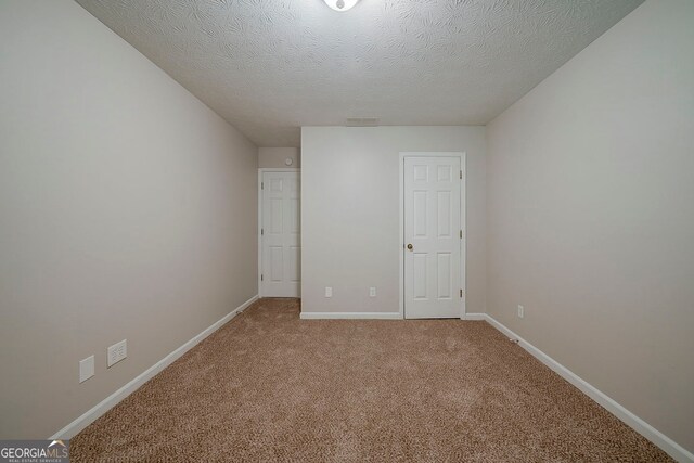 228 Amour Way SW, Lilburn, GA 30047 - unfurnished bedroom with carpet flooring and a textured ceiling