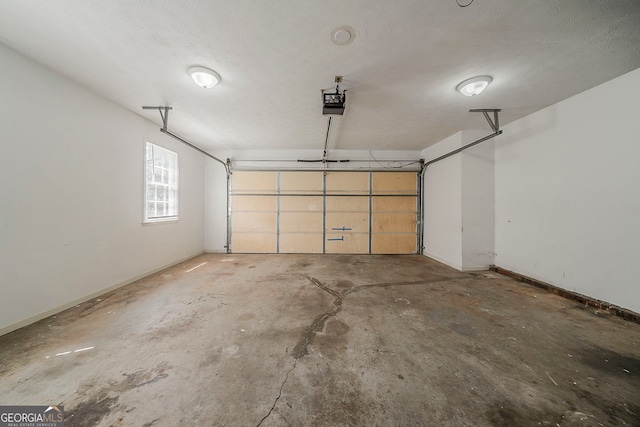 228 Amour Way SW, Lilburn, GA 30047 - garage featuring a garage door opener and baseboards