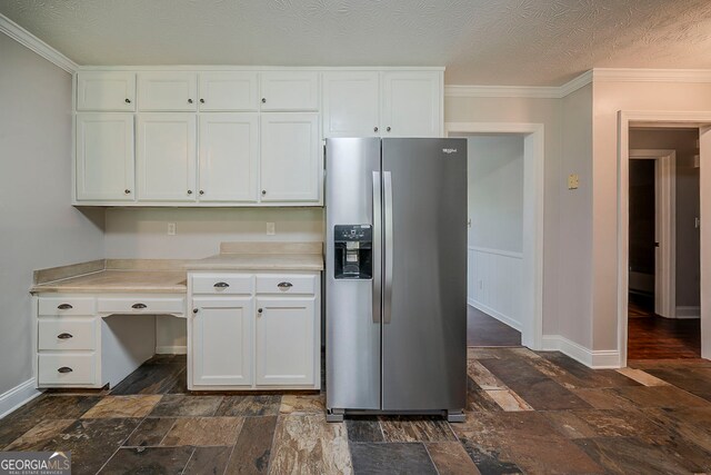 228 Amour Way SW, Lilburn, GA 30047 - kitchen with stainless steel refrigerator with ice dispenser, stone tile flooring, white cabinetry, light countertops, and crown molding