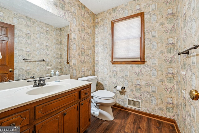 1366 Maple Ridge Dr, Suwanee, GA 30024 - bathroom featuring visible vents, vanity, wood finished floors, toilet, and baseboards