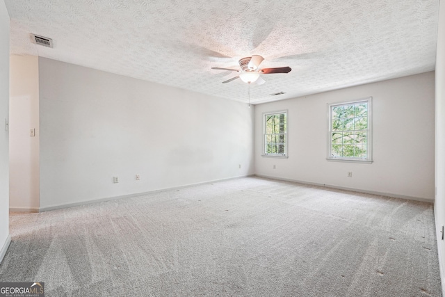 1366 Maple Ridge Dr, Suwanee, GA 30024 - carpeted empty room featuring a textured ceiling, ceiling fan, visible vents, and baseboards