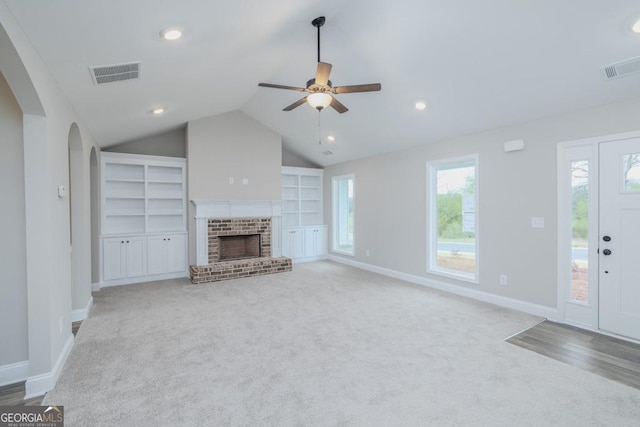 280 Grady Brock Rd Lot 21, Martin, GA 30557 - unfurnished living room featuring carpet flooring, a ceiling fan, arched walkways, a fireplace, and vaulted ceiling