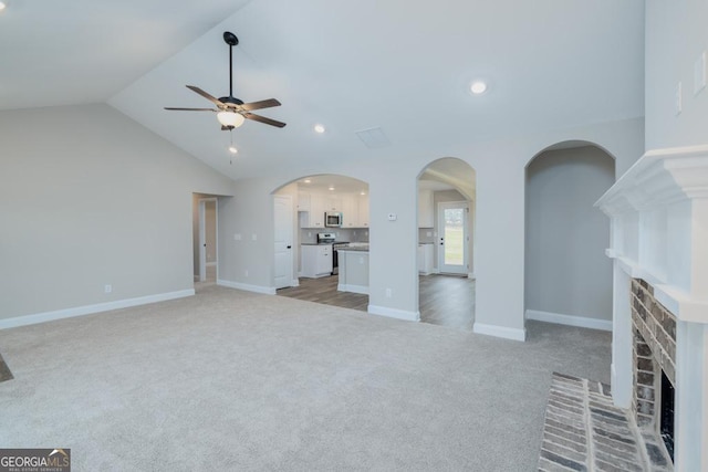 280 Grady Brock Rd Lot 21, Martin, GA 30557 - unfurnished living room with a brick fireplace, light colored carpet, ceiling fan, lofted ceiling, and arched walkways