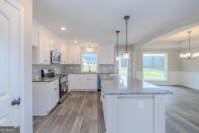 280 Grady Brock Rd Lot 21, Martin, GA 30557 - kitchen with stainless steel appliances, light wood finished floors, arched walkways, white cabinets, and a center island