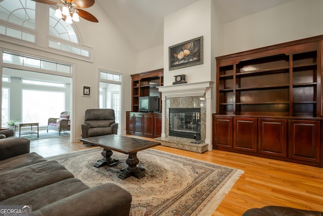 229 Deer Haven Run, Carlton, GA 30627 - living area with a healthy amount of sunlight, a high end fireplace, light wood finished floors, and high vaulted ceiling