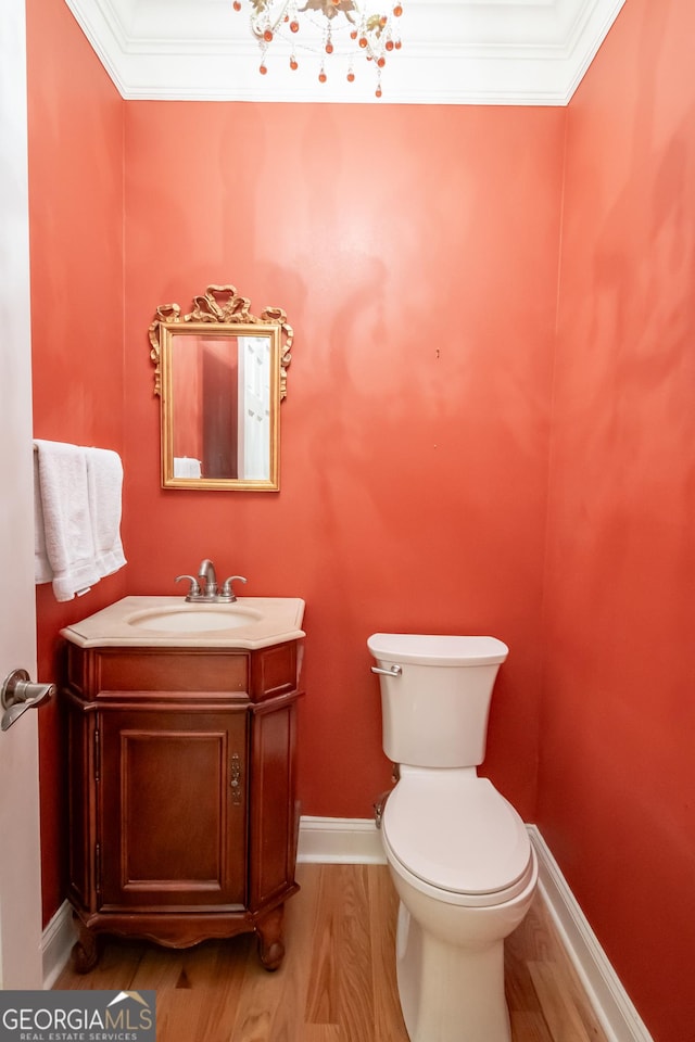 229 Deer Haven Run, Carlton, GA 30627 - half bathroom with wood finished floors, vanity, baseboards, toilet, and ornamental molding