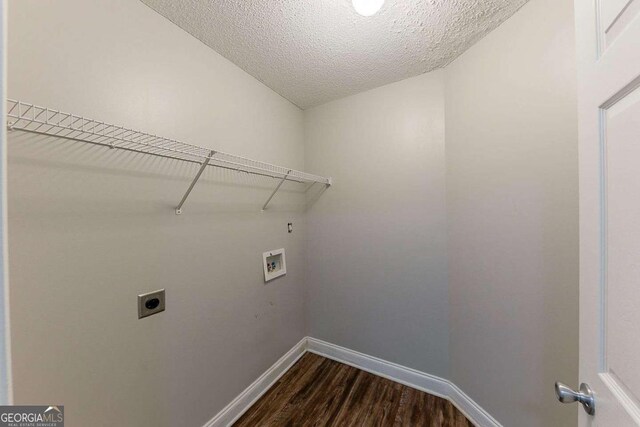 laundry area featuring laundry area, baseboards, dark wood finished floors, electric dryer hookup, and washer hookup