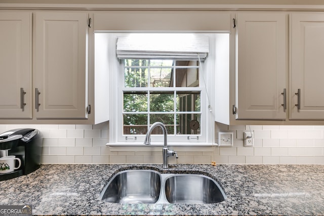 375 Spindle Ct, Sandy Springs, GA 30350 - kitchen featuring a sink, light stone counters, and backsplash