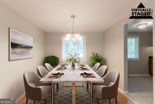 dining area featuring an inviting chandelier and baseboards