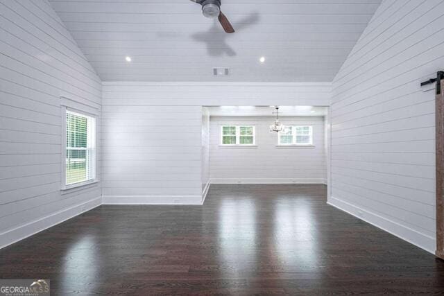 211 Hogan Coweta Rd, Hogansville, GA 30230 - empty room featuring baseboards, vaulted ceiling, dark wood finished floors, and ceiling fan with notable chandelier