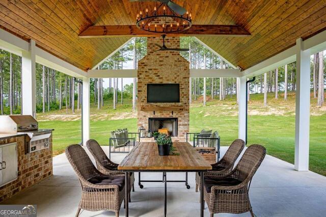 211 Hogan Coweta Rd, Hogansville, GA 30230 - sunroom featuring area for grilling, beamed ceiling, outdoor dining space, and an outdoor brick fireplace