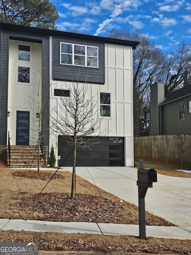 503 Glendale Rd Unit 0, Scottdale, GA 30079 - view of front of home with concrete driveway, an attached garage, and board and batten siding