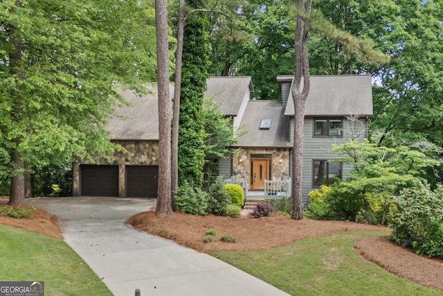 view of front of house featuring stone siding, driveway, roof with shingles, a chimney, and covered porch