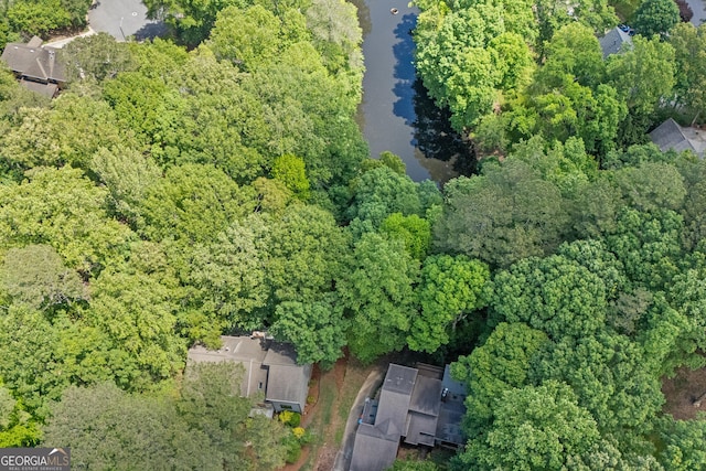 bird's eye view featuring a wooded view and a water view